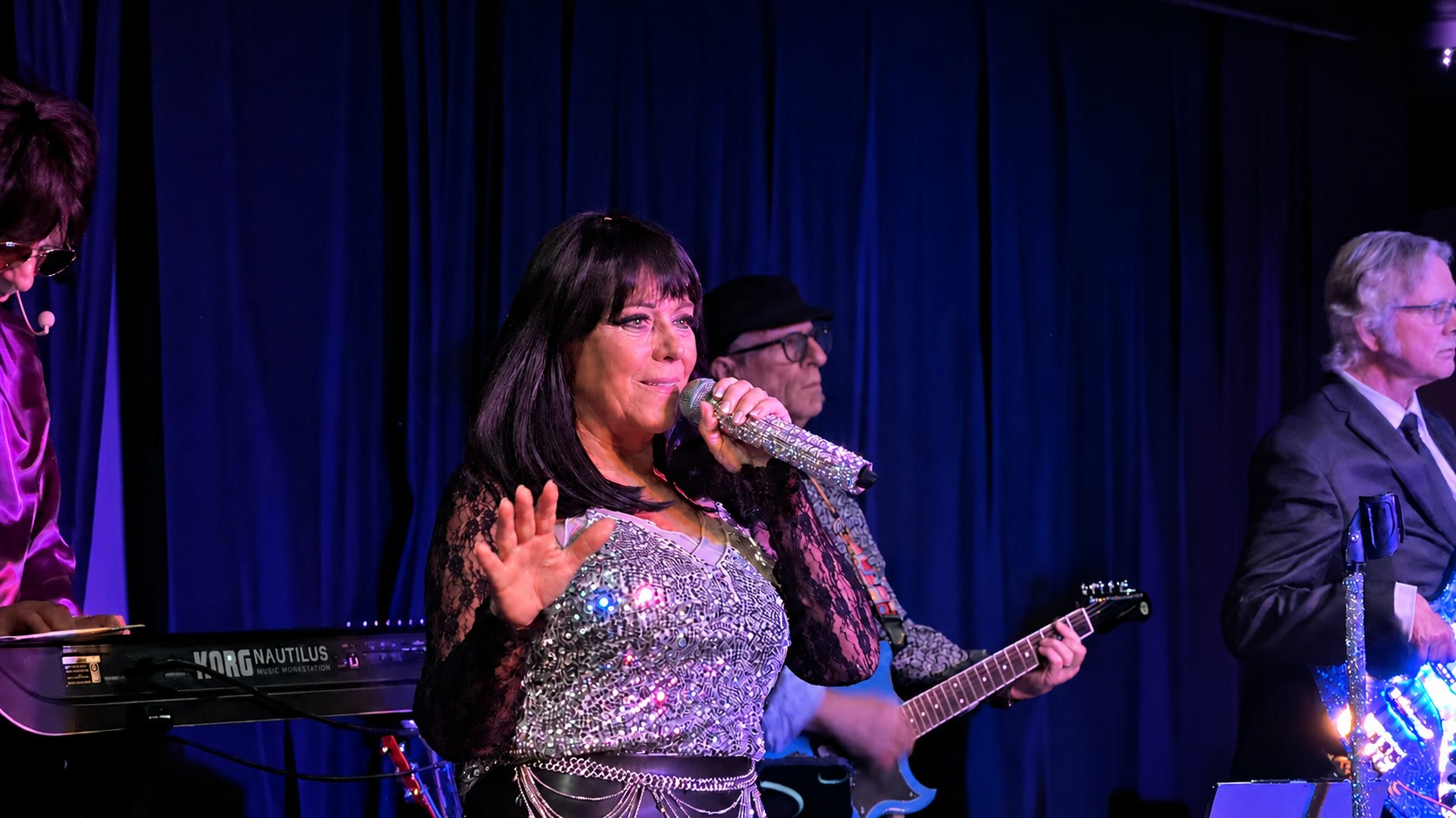 Cher Alike singing on stage in a sequined top