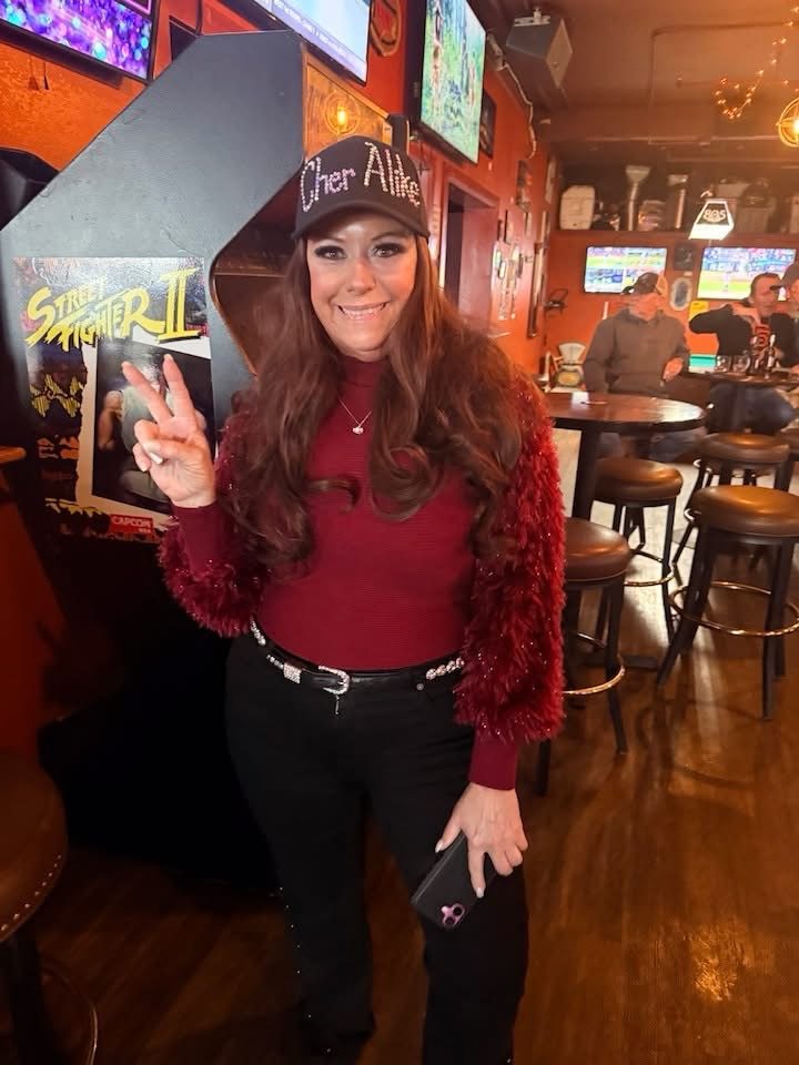 Cher Alike at a live venue wearing the branded cap